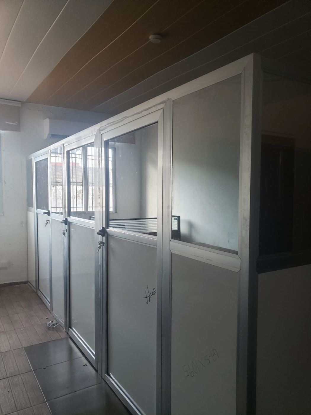 Row of glazed office partitions with lockable doors